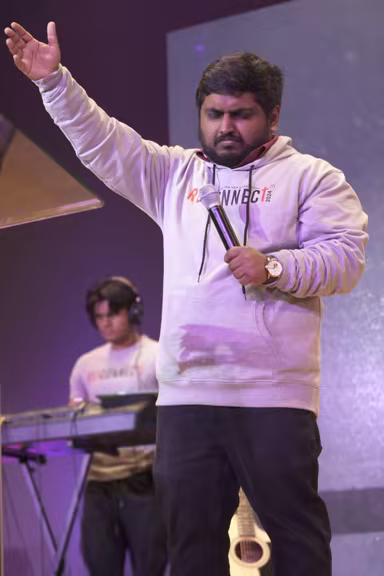 Student vocalist leading worship during an ICPF Canada event