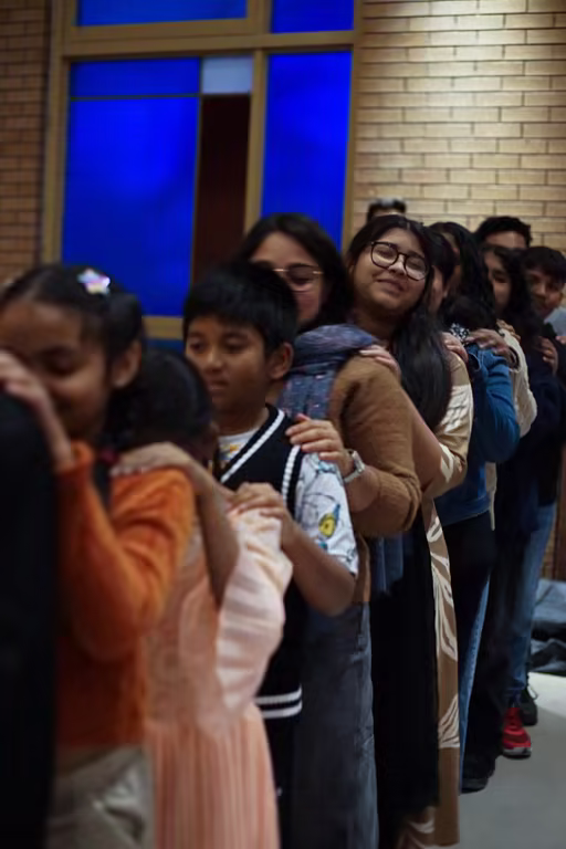 Students standing together in a joyful ICPF Canada community moment